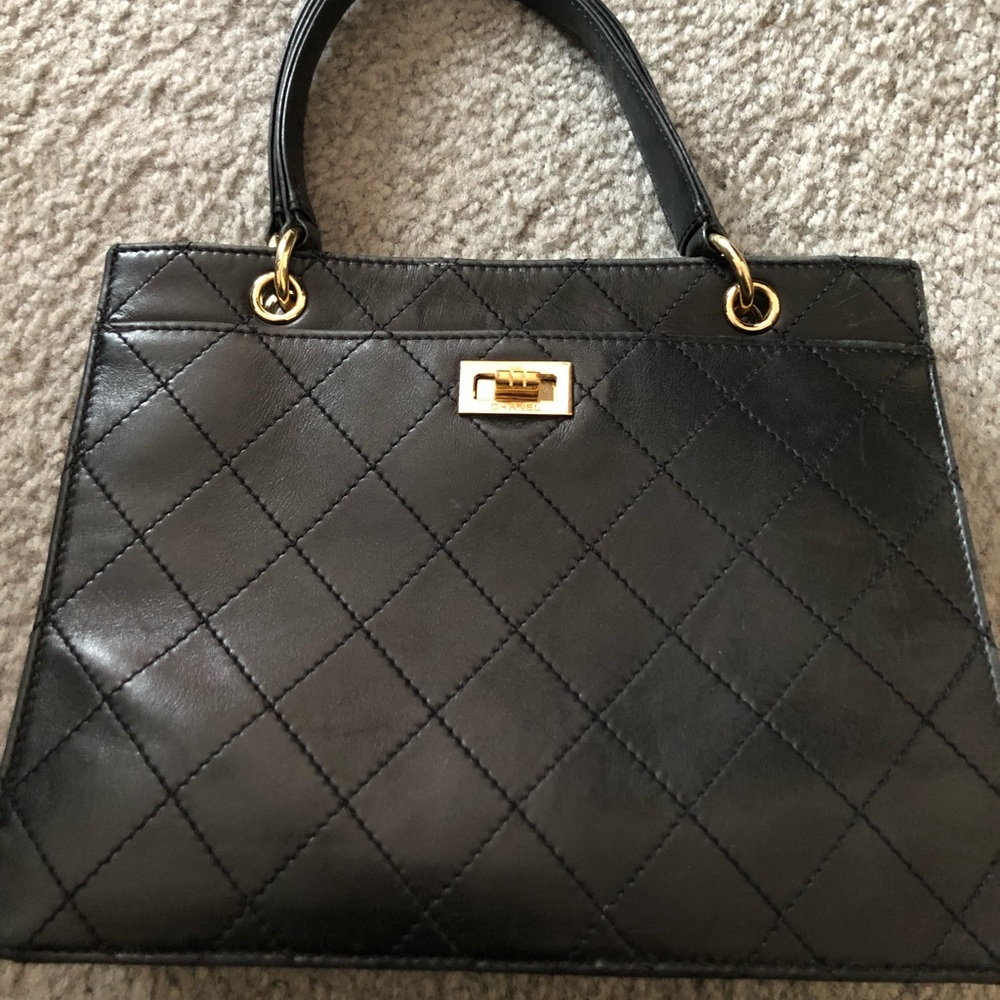 Vintage-authentic Chanel black leather handbag.